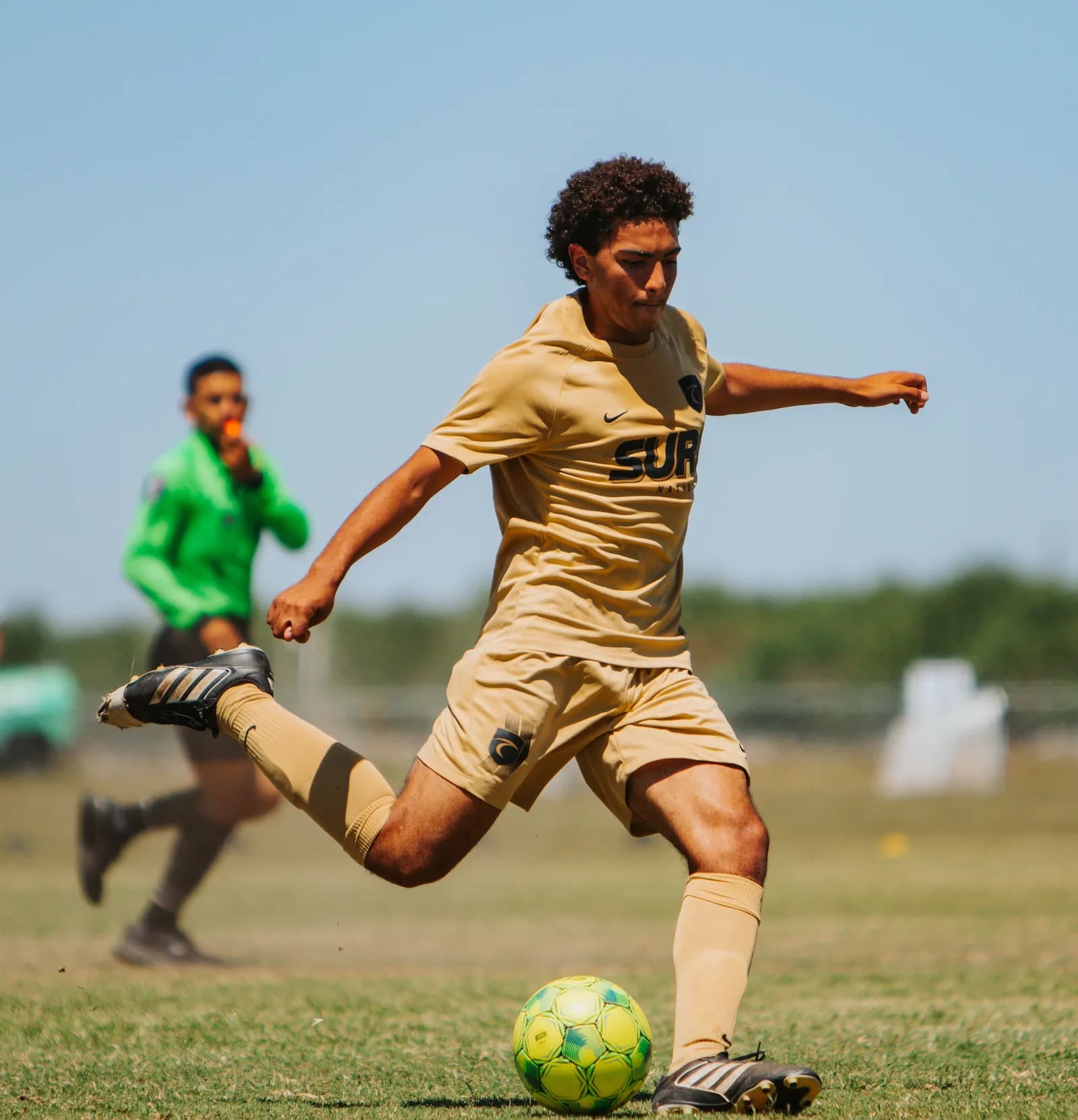 South Valley Surf boys player striking the ball in a competitive match