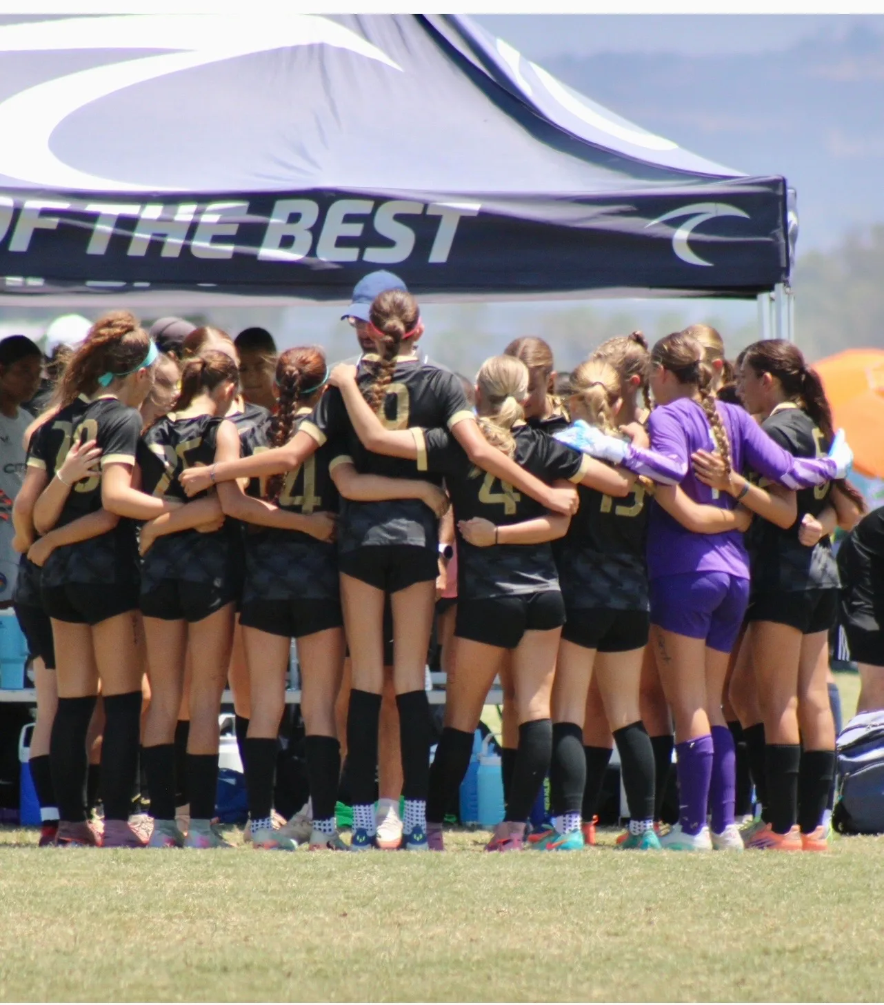 South Valley Surf girls huddling under the team tent at a tournament
