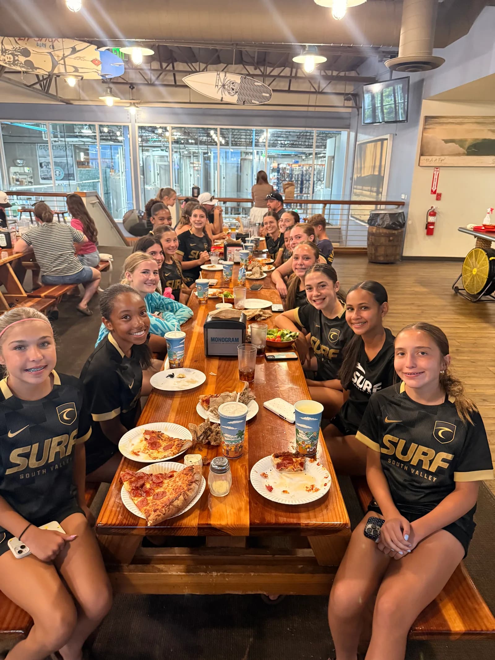 South Valley Surf players sharing a team pizza dinner after a match day